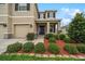 Inviting front entrance featuring a dark front door, decorative shutters, and lush landscaping at 8110 Sw 59Th Ter, Ocala, FL 34476