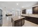 An open concept kitchen flows into the living area, featuring a center island with granite countertops at 8110 Sw 59Th Ter, Ocala, FL 34476