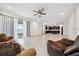 The open living room offers access to the kitchen and backyard, and features neutral tile and a ceiling fan at 8110 Sw 59Th Ter, Ocala, FL 34476