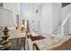 Bright living room with high ceilings, tile floors, elegant decor, and staircase at 8110 Sw 59Th Ter, Ocala, FL 34476