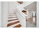 Staircase with wood treads and white risers leads to the upper level, with a view of the hallway at 8110 Sw 59Th Ter, Ocala, FL 34476