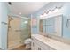 Bathroom featuring glass shower, updated vanity, and a matching mirror at 8745 Sw 92Nd St # B, Ocala, FL 34481