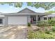 Charming home with a well-manicured lawn, attached garage, and a welcoming red front door at 8745 Sw 92Nd St # B, Ocala, FL 34481