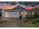 Charming home with a well-manicured lawn, attached garage, and a welcoming red front door at 8745 Sw 92Nd St # B, Ocala, FL 34481