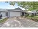 Home with a 2-car garage, covered porch, and a well-maintained lawn and landscaping at 8745 Sw 92Nd St # B, Ocala, FL 34481
