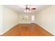 Bright living room with hardwood floors, ceiling fan, and natural light from windows at 8745 Sw 92Nd St # B, Ocala, FL 34481