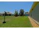 Expansive backyard featuring lush green grass and mature landscaping, offering ample space for outdoor activities at 9068 Se 120Th Loop, Summerfield, FL 34491