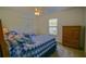 Comfortable bedroom with twin beds, ceiling fan, closet, and a dresser, offering a relaxing space at 9068 Se 120Th Loop, Summerfield, FL 34491