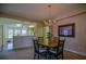 Charming dining area with chandelier next to a kitchen pass-through at 9068 Se 120Th Loop, Summerfield, FL 34491