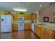 Bright eat-in kitchen with wood cabinets and modern appliances featuring a large countertop at 9068 Se 120Th Loop, Summerfield, FL 34491