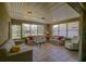 Bright sunroom with multiple windows and comfortable seating, perfect for relaxation and enjoying the outdoor view at 9068 Se 120Th Loop, Summerfield, FL 34491