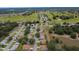 High-angle view of the property, revealing its position near a golf course at 9891 Se 138Th Loop, Summerfield, FL 34491