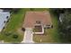 Overhead shot of a well-kept home with tidy landscaping, a neat lawn and a two-car garage at 9891 Se 138Th Loop, Summerfield, FL 34491