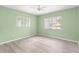 Bright bedroom with laminate flooring, ceiling fan, and natural light at 9891 Se 138Th Loop, Summerfield, FL 34491