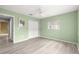 Cozy bedroom with laminate flooring, a ceiling fan, and ample closet space at 9891 Se 138Th Loop, Summerfield, FL 34491