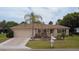 Charming home with well-maintained lawn, mature palm tree, and two-car garage at 9891 Se 138Th Loop, Summerfield, FL 34491