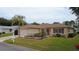 Well-kept home with a manicured lawn, mulch beds, and a two-car garage at 9891 Se 138Th Loop, Summerfield, FL 34491