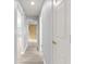 Bright hallway with light gray walls and modern wood-look flooring leading to various rooms in the home at 9891 Se 138Th Loop, Summerfield, FL 34491