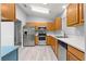 Bright kitchen features stainless steel appliances, wooden cabinets, and light countertops at 9891 Se 138Th Loop, Summerfield, FL 34491