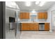 Renovated kitchen features stainless steel appliances, bright countertops, and wood cabinets at 9891 Se 138Th Loop, Summerfield, FL 34491