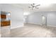 Bright living room area with modern flooring, ceiling fan, and easy access to the kitchen and bathroom at 9891 Se 138Th Loop, Summerfield, FL 34491