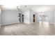 Open-concept living area with modern flooring, leading to the kitchen and dining area, with recessed lighting at 9891 Se 138Th Loop, Summerfield, FL 34491