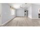 Expansive living room with sleek, wood-look flooring and a contemporary ceiling fan, ideal for relaxation at 9891 Se 138Th Loop, Summerfield, FL 34491