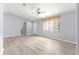 Bright living room area with modern flooring, ceiling fan, and natural light from a large window at 9891 Se 138Th Loop, Summerfield, FL 34491