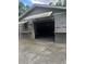 A detached garage featuring an awning and visible shelving at 1101 Se 33Rd Ave, Ocala, FL 34471