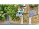Aerial view showing house, yard, pool, neighborhood, and mature tree coverage at 111 Almond Rd, Ocala, FL 34472