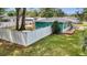 Backyard features lush lawn, privacy fence, mature trees and an exterior view of the home at 111 Almond Rd, Ocala, FL 34472