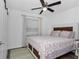 Bright bedroom with a ceiling fan, large window, and barn doors at 111 Almond Rd, Ocala, FL 34472