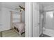 Light-filled bedroom with a ceiling fan and an ensuite bathroom at 111 Almond Rd, Ocala, FL 34472