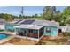 A sunny screened-in porch and solar panels adorn the backyard with patio and pool at 111 Almond Rd, Ocala, FL 34472