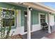 Welcoming front porch with brick accents, outdoor seating, and stylish exterior lighting at 111 Almond Rd, Ocala, FL 34472