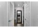 Hallway view with large mirror, interior doors, and views into other rooms at 111 Almond Rd, Ocala, FL 34472