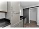 Kitchen featuring gray cabinets and countertops, as well as a sliding door at 111 Almond Rd, Ocala, FL 34472