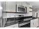 Updated kitchen with stainless steel appliances, granite countertops, and white subway tile at 111 Almond Rd, Ocala, FL 34472