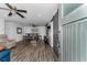 Open-concept living room featuring wood floors, modern lighting, and dining area at 111 Almond Rd, Ocala, FL 34472