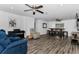 Spacious living room with hardwood floors, modern decor, and ceiling fan at 111 Almond Rd, Ocala, FL 34472