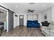Bright living room with barn door, modern furnishings, and wood laminate flooring at 111 Almond Rd, Ocala, FL 34472