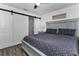 Comfortable main bedroom featuring a sliding barn door and ensuite bathroom with gray wood-look flooring at 111 Almond Rd, Ocala, FL 34472