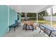 Covered and screened in patio with dining table and seating overlooking the backyard at 111 Almond Rd, Ocala, FL 34472