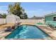 Swimming pool with paved patio, privacy fence, and sitting area in the backyard at 111 Almond Rd, Ocala, FL 34472