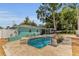 Aerial shot of a backyard pool with a patio, lounge chairs, a privacy fence and shed at 111 Almond Rd, Ocala, FL 34472