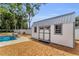 Exterior view of shed next to a swimming pool with privacy fence and landscaping at 111 Almond Rd, Ocala, FL 34472