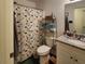 Bathroom with dinosaur-themed shower curtain and vanity at 120 Fisher Ct, Ocklawaha, FL 32179