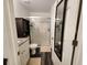 Bathroom with tiled shower, granite countertop, and modern fixtures at 120 Fisher Ct, Ocklawaha, FL 32179