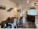 View from dining area showing vinyl flooring, table, and a glimpse into the adjacent living room at 120 Fisher Ct, Ocklawaha, FL 32179