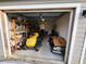 View of the garage's interior showing shelving and storage of equipment and other items at 120 Fisher Ct, Ocklawaha, FL 32179